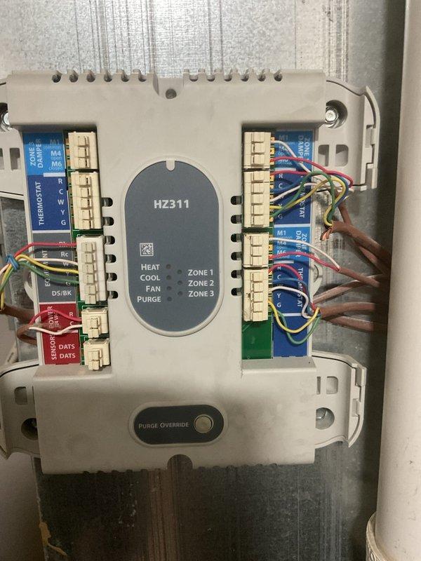 Completed comprehensive HVAC system replacement estimate for residential property. Evaluated existing outdoor condenser unit and multi-zone control system with HZ311 zone controller managing three separate zones. Documented current equipment configuration including thermostat control panel, zone damper wiring, refrigerant line connections, electrical disconnect, and outdoor unit placement on concrete pad. Photographed all major system components to support replacement recommendations and provided estimate for complete system replacement.
