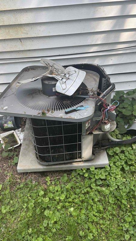 Conducted on-site evaluation of 20+ year old residential air conditioning system for replacement estimate. Outdoor condenser unit exhibited severe deterioration including damaged fan grille with warped metal mesh, loose electrical connections, and significant wear on exterior casing. Documented equipment condition and assessed indoor components including evaporator coil accessibility in basement utility area. Provided comprehensive replacement recommendations for complete system upgrade due to age and deteriorated condition of existing equipment.