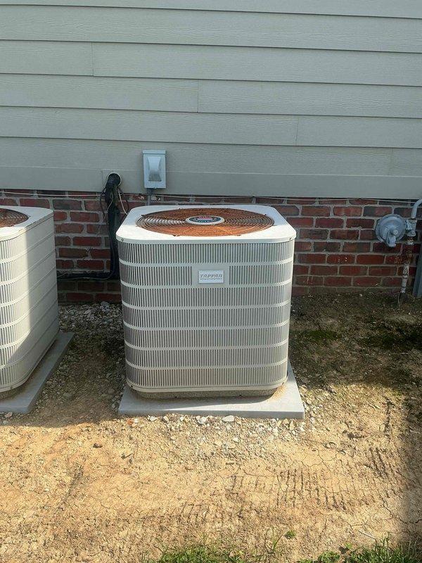 Completed comprehensive assessment of existing HVAC system for replacement estimate. Evaluated indoor furnace unit located in basement utility room and outdoor air conditioning condenser unit positioned on concrete pad against home's exterior foundation. Documented current equipment configuration including copper refrigerant line routing, electrical connections, and existing installation conditions. Photographed both interior and exterior components to provide detailed visual documentation for Green - A+ rated replacement system proposal. Assessment confirmed equipment accessibility and identified installation requirements for complete system upgrade.