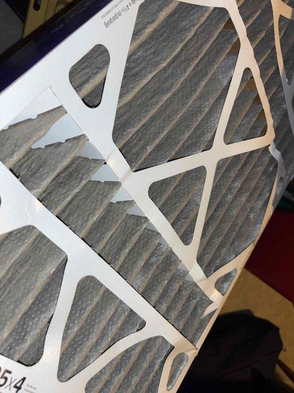 Responded to callback for system not cooling after previous service visit where core sense was bypassed and amp draws verified normal operation. Upon arrival, found extremely dirty air filter causing restricted airflow and reduced cooling capacity. Replaced filter and verified thermostat operation showing system set to 54°F with cool mode engaged. System cycling properly with adequate airflow restored after filter replacement.