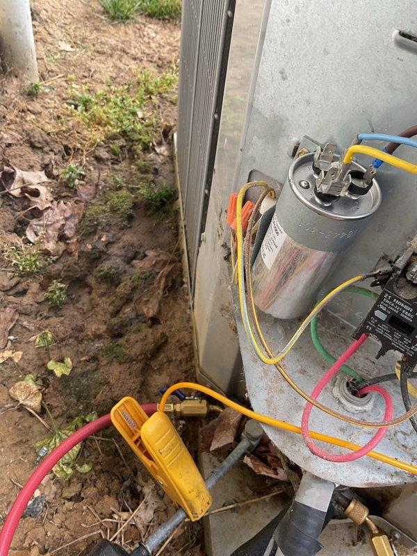 Responded to no-cool call on 13-year-old residential system where thermostat was set to cool but indoor fan would not activate. Upon arrival, confirmed no power to outdoor condensing unit and indoor blower motor inoperative. Performed comprehensive diagnostic testing using refrigerant manifold and micron gauge at outdoor unit. Tested electrical components including capacitor connections and contactor operation. Identified failed capacitor as primary cause of system failure, evidenced by lack of compressor and condenser fan motor operation. Replaced defective dual-run capacitor with proper MFD-rated component, reconnected all electrical terminals, and verified proper wire connections. Cycled system through complete operational test, confirmed compressor startup, verified condenser fan motor operation, and checked refrigerant pressures within manufacturer specifications. System restored to full cooling operation with all components functioning normally.
