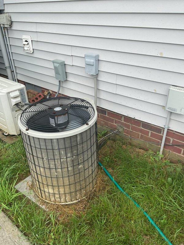 Conducted comprehensive HVAC system replacement estimate for residential property with currently operational equipment. Evaluated existing outdoor condenser unit showing age-related weathering and assessed downflow furnace configuration with coil assembly, documenting precise dimensional requirements including 104-inch height clearance, existing wooden base platform, and equipment positioning against exterior wall with vinyl siding and brick foundation. Provided homeowner with complete replacement options and system upgrade recommendations during standard estimate consultation.