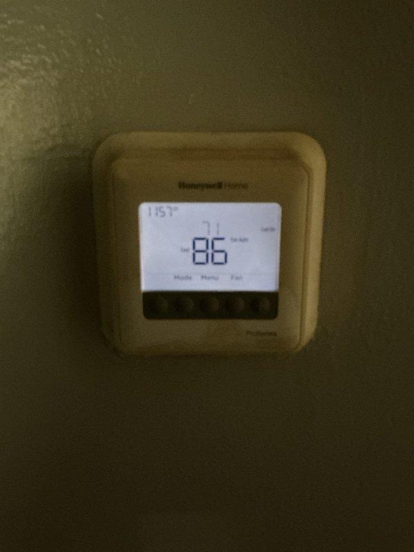Responded to no cooling complaint on residential air conditioning system. Upon arrival, found thermostat displaying 86°F with unit running but not producing cold air. Performed diagnostic testing on outdoor condensing unit using digital multimeter. Testing revealed failed capacitor preventing compressor from operating properly. Replaced defective dual-run capacitor with new unit, verified proper microfarad readings, and confirmed all electrical connections secure. System tested successfully with compressor engaging and cold air production restored to normal operation.