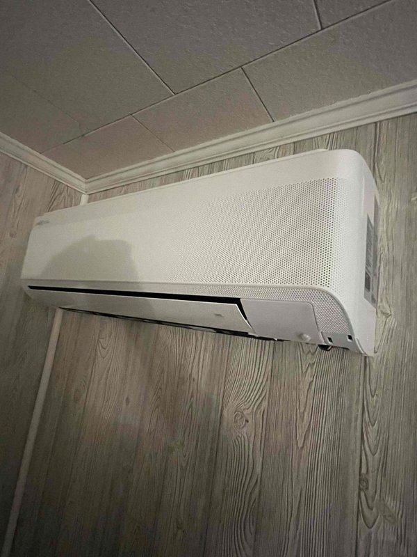 Completed installation of a 9,000 BTU single-head ductless mini-split system. Outdoor condenser unit was mounted on a concrete pad on brick paver patio with refrigerant lines and electrical disconnect box properly installed on exterior vinyl siding. Indoor wall-mounted air handler was installed in interior space with professional line set routing and all connections completed per manufacturer specifications.
