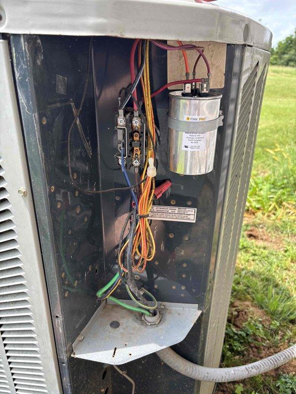 Completed planned maintenance on 13-year-old residential HVAC system. Performed electrical diagnostics using digital multimeter, verifying system voltage and component functionality. Inspected outdoor condensing unit with access panel removed, examining TITAN PRO capacitor, contactors, relays, and control board. Verified proper wire connections throughout unit including power and control wiring. System operating within normal parameters. Recommended 16x25x1 filter replacement for continued optimal performance.