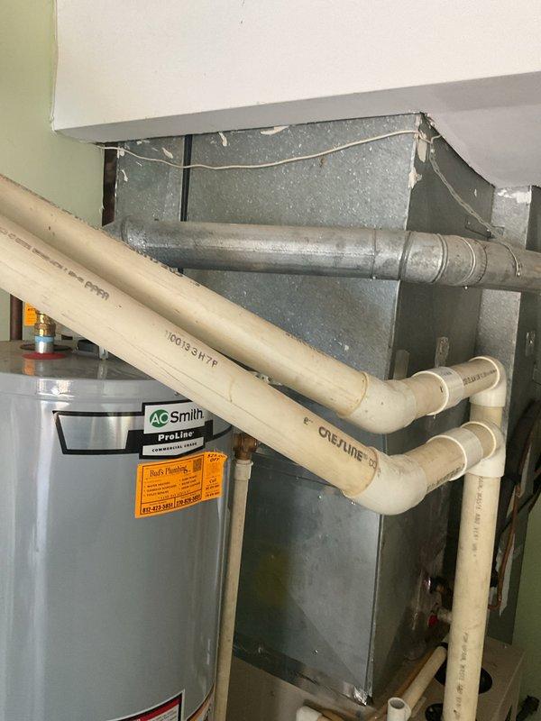 Conducted comprehensive site assessment for cooling system replacement at medium-sized residential property (1600-2200 sq.ft.). Evaluated existing HVAC infrastructure located in garage area, including air handler unit with galvanized ductwork, associated mechanical systems, and utility connections. Documented current equipment configuration and mechanical room layout to provide replacement options for 25-year-old cooling system, photographing existing installation including ductwork routing, PVC plumbing connections, and spatial constraints for new equipment installation.