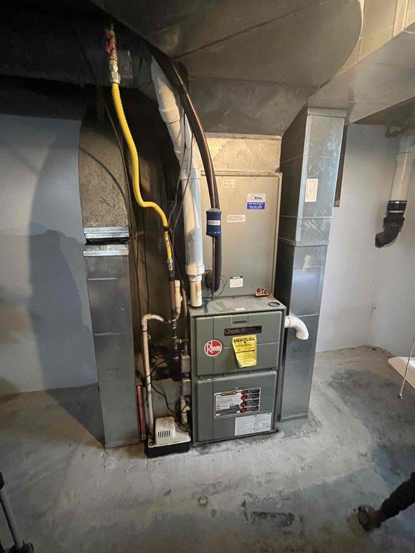 Conducted follow-up replacement estimate for existing HVAC system in residential basement. Evaluated current Rheem furnace installation including gas line connections, copper refrigerant lines, PVC condensate drainage, and ductwork configuration. Assessed electrical service panel capacity and existing circuit assignments for furnace compatibility. Documented equipment specifications and existing infrastructure to provide updated replacement proposal for complete system changeover.