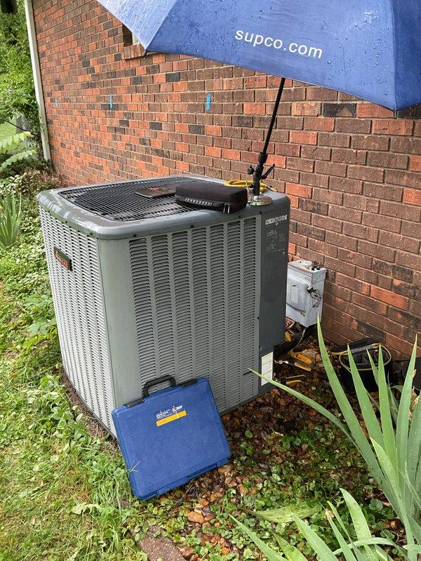 # HVAC Service Call - No Cooling Issue

Responded to service call for 9-year-old heat pump system with no cooling complaint. Upon arrival, performed visual inspection of outdoor condenser unit and electrical disconnect box. Found outdoor equipment accessible and positioned against brick wall exterior with adequate clearance for service access.

Conducted diagnostic evaluation of condenser unit to identify cause of cooling failure. Utilized diagnostic tools and equipment to assess system operation and electrical components. Inspected electrical disconnect box mounted on exterior wall, noting weathered condition with visible corrosion and deterioration affecting enclosure integrity.

Performed comprehensive system assessment including examination of outdoor unit components, electrical connections, and overall equipment condition. Documented equipment installation and current state with photographic evidence for service records and customer communication.

Contacted customer remotely as r