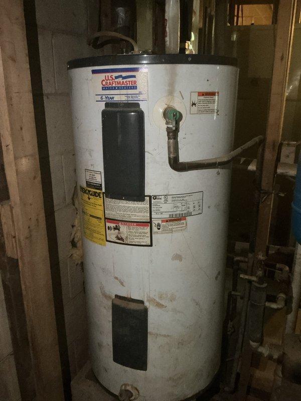 Responded to service call for water heater and well pump inspection following previous flood damage that resulted in 8 feet of water in the home. Upon arrival, conducted thorough assessment of existing U.S. Craftmaster water heater with 6.75M capacity, which exhibited significant deterioration including extensive rust staining, discoloration, and visible wear throughout the tank exterior, particularly concentrated on the lower third of the unit. Inspected well pump system including blue pressurized expansion tank mounted on metal frame platform and horizontal circulation pump with associated piping connections. Documented condition of all equipment with photographs showing compromised water heater condition likely resulting from flood exposure. Evaluated pressure tank, pump assembly, copper piping, valves, and electrical connections for proper operation and signs of water damage. Provided customer with assessment findings regarding water heater condition and recommendations for replace