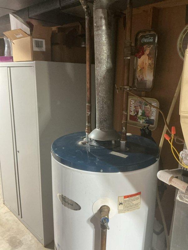 Responded to no hot water complaint affecting entire residence. Upon arrival, inspected gas water heater located in basement utility area. Diagnosed pilot light failure preventing burner ignition. Verified gas supply to unit, checked thermocouple functionality, and cleared pilot assembly of debris. Successfully relit pilot light, confirmed proper flame characteristics, and tested burner operation through full heating cycle. Verified hot water restoration at fixtures throughout home and ensured all safety controls functioning properly before departing.