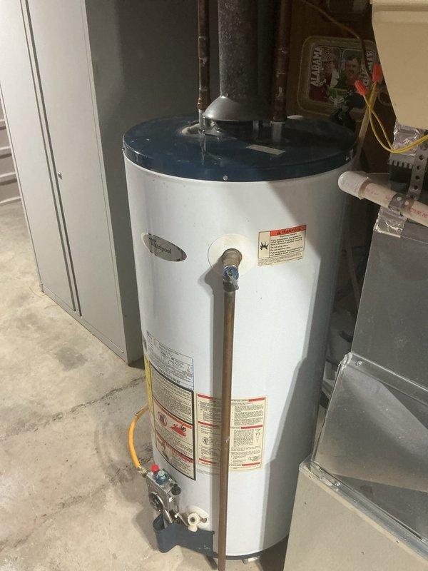 Responded to no hot water complaint affecting entire residence. Upon arrival, inspected gas water heater located in basement utility area. Diagnosed pilot light failure preventing burner ignition. Verified gas supply to unit, checked thermocouple functionality, and cleared pilot assembly of debris. Successfully relit pilot light, confirmed proper flame characteristics, and tested burner operation through full heating cycle. Verified hot water restoration at fixtures throughout home and ensured all safety controls functioning properly before departing.