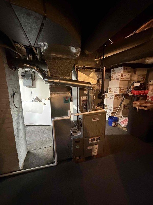 Completed full HVAC system installation including a 2-ton, 14.7 SEER outdoor condensing unit and 80% AFUE furnace in basement mechanical room. Performed system startup, refrigerant charging, and verification of proper operation using manifold gauges with measured temperatures of 151.7°F and 152°F and pressures of 228.9 and 106.3 PSI, confirming system is operating within manufacturer specifications.