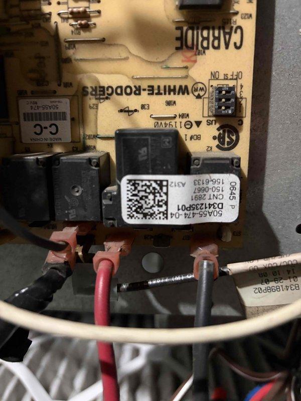 Responded to no cooling call on 3-year-old system with frozen evaporator coil. Upon arrival, confirmed ice buildup and instructed occupant to switch system to fan-only mode to initiate defrost process. Inspected White-Rodgers InteliHARMONY control board for proper operation and verified all electrical connections and wiring terminals were secure. Property has secondary cooling system available during defrost period.