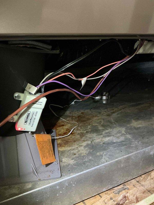 Responded to callback for no cooling on recently installed unit. Upon inspection, discovered unit was not level, causing condensate drainage issues as evidenced by significant rust staining on drain pan. Leveled equipment using spirit level to ensure proper operation and drainage, verified all electrical connections were secure, and checked refrigerant system operation. Unit now functioning properly with adequate cooling and proper condensate flow.