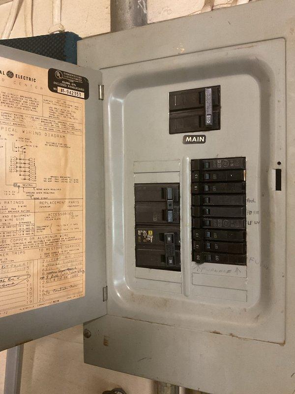 Conducted comprehensive replacement estimate for aging HVAC system over 15 years old that is currently operational but nearing end of service life. Evaluated existing thermostat wiring configuration showing 24VAC connections with standard color-coded wiring to terminal block, and assessed electrical service panel with main breaker and circuit distribution to ensure adequate power supply for new equipment installation. Documented system specifications and captured detailed photos of control wiring and electrical infrastructure to develop accurate replacement proposal and equipment sizing recommendations.