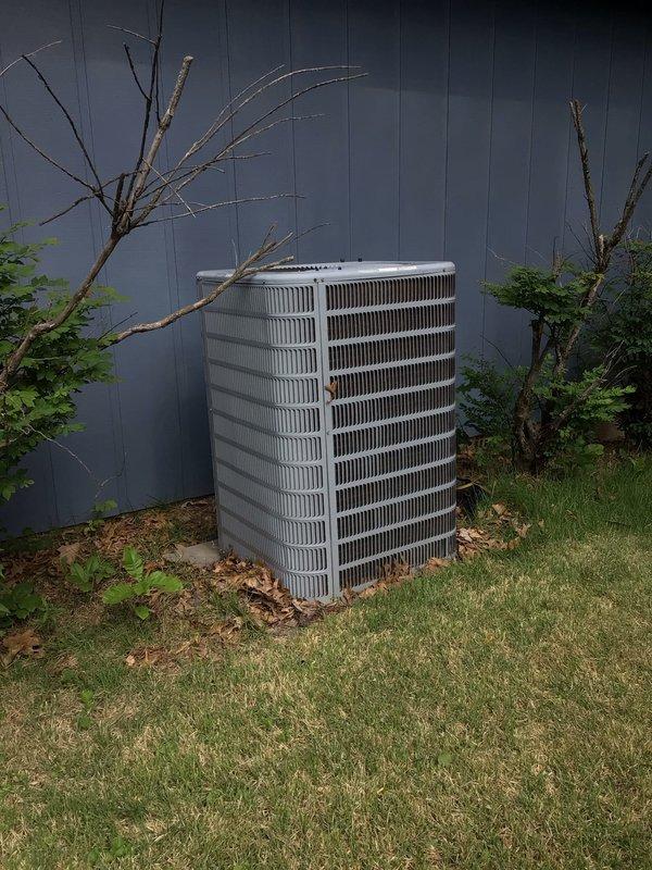 Responded to no-cool service call on 4-year-old system with frozen evaporator coil and minimal airflow. Upon arrival, confirmed air handler had been shut off to allow ice buildup to thaw, with secondary cooling system operational in office area. Inspected outdoor condenser unit positioned against building exterior with adequate clearance, confirmed unit operational with proper electrical connections. Examined indoor air handler and evaporator coil assembly with refrigerant lines and connections intact. System had been running with thermostat set to 74°F while ambient temperature reached 80°F, creating excessive demand. After thaw period completed, verified airflow restoration and proper system operation, checking refrigerant line connections and valve assemblies for leaks or restrictions.