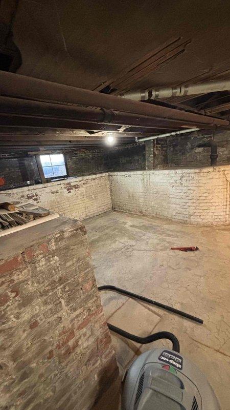 Conducted comprehensive HVAC system replacement estimate for property currently relying on window units. Assessment included evaluation of unfinished basement space with exposed infrastructure and crawl space conditions, identifying need for complete ductwork installation in addition to new air conditioning system. Documented existing conditions including moisture concerns evidenced by dehumidifier presence in basement, aged plumbing infrastructure with corrosion, and structural considerations for new duct routing through exposed joists and support beams. Provided detailed replacement specifications for full HVAC system installation including proper duct design to serve all conditioned spaces.