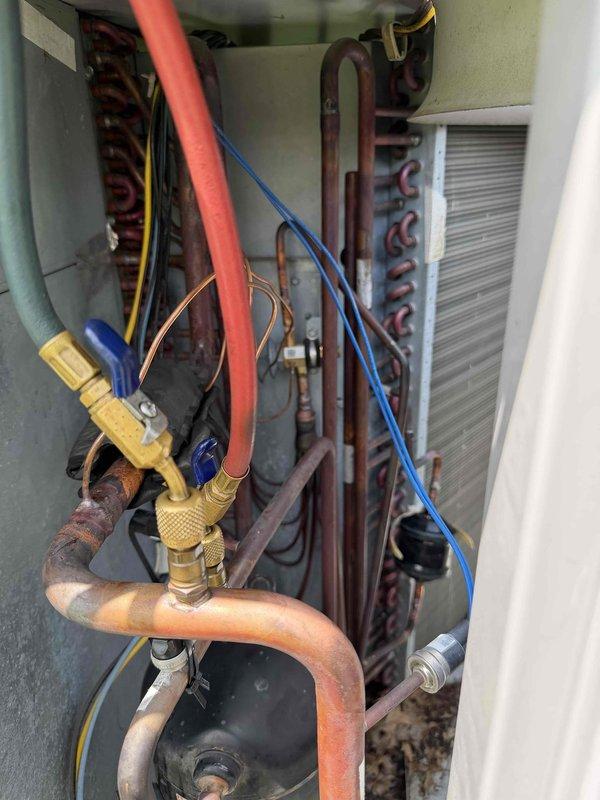 Responded to no cooling complaint on Carrier package unit located at barn structure. Upon arrival, performed complete system diagnostics using manifold gauges to assess refrigerant pressures and system performance. Inspection revealed inadequate cooling capacity and abnormal operating pressures consistent with thermostatic expansion valve (TXV) malfunction. Accessed internal components through service panel to examine refrigerant circuit, including copper lines, service valves, and evaporator coil assembly. Confirmed TXV failure affecting proper refrigerant metering and system efficiency. Documented existing conditions with photographs showing internal components and exterior unit configuration. Provided customer with diagnosis and recommended TXV replacement to restore proper cooling function. Estimated repair time of two hours for parts replacement once component is obtained. System temporarily left in safe operating condition pending parts availability and scheduled repair completio