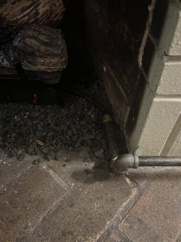 Responded to report of gas odor near fireplace. Conducted comprehensive gas leak detection survey of accessible gas piping system, including lines servicing fireplace appliance in basement area. Performed visual inspection of exposed gas piping, fittings, and connections along walls and floor-mounted runs. Utilized gas detection equipment to test all accessible joints, valves, and pipe connections. No active gas leaks detected during pressure testing and leak survey. Verified all connections secure and system maintaining proper pressure. Documented piping configuration and condition with photographic evidence for service records.