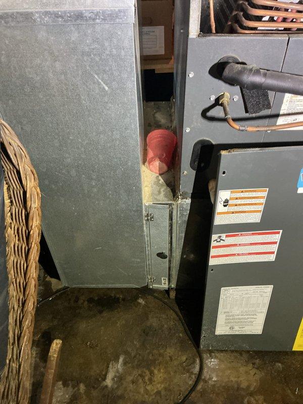 Responded to no-cooling call on 19-year-old residential HVAC system with frozen evaporator coil. Upon arrival, unit was shut down with indoor temperature at 79°F. Conducted diagnostic evaluation of outdoor condenser unit and attic-mounted air handler to identify cause of coil freeze-up. Inspected refrigerant lines, airflow components, and electrical connections on aging equipment. Documented system condition with photographic evidence showing outdoor condenser unit mounted on concrete pad with associated electrical disconnect and indoor air handler with visible wear and dust accumulation. Advised homeowner on findings related to system age and performance issues affecting cooling capacity.