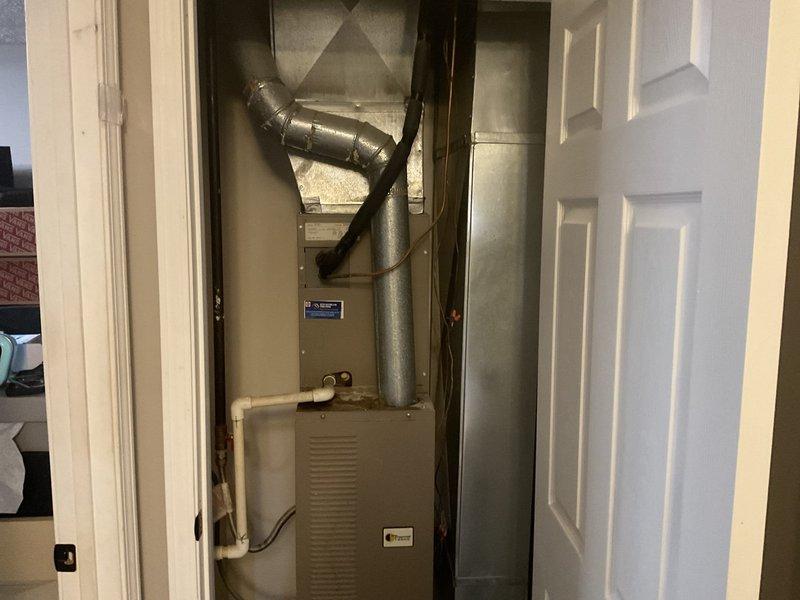 Performed comprehensive HVAC replacement estimate for residential property. Evaluated existing furnace and air handler system located in interior closet space, documenting current equipment configuration including ductwork connections, condensate drain lines, and spatial constraints. Assessed installation accessibility, measured available clearances for replacement equipment, and photographed existing system components to determine optimal replacement unit specifications and installation requirements.