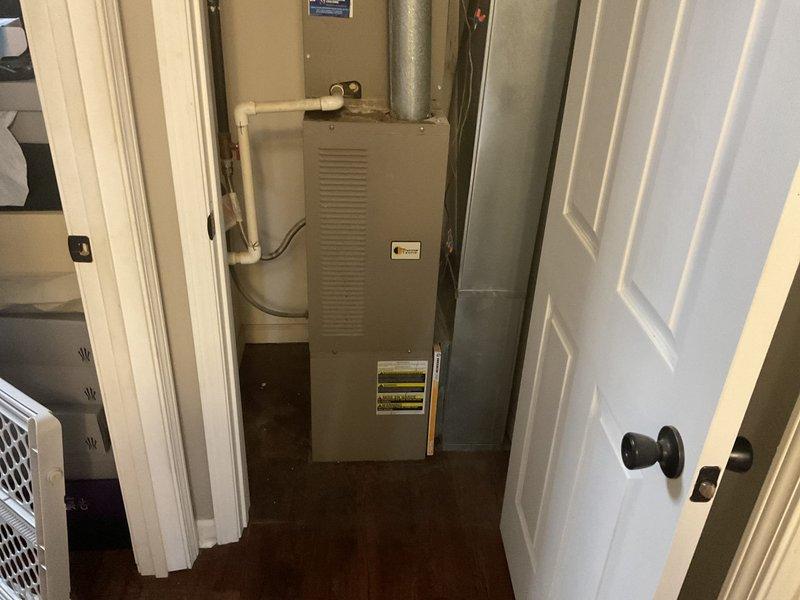 Performed comprehensive HVAC replacement estimate for residential property. Evaluated existing furnace and air handler system located in interior closet space, documenting current equipment configuration including ductwork connections, condensate drain lines, and spatial constraints. Assessed installation accessibility, measured available clearances for replacement equipment, and photographed existing system components to determine optimal replacement unit specifications and installation requirements.