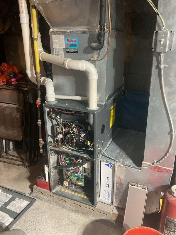Completed annual planned maintenance visit on 8-year-old residential HVAC system. Performed comprehensive inspection of furnace unit with all access panels removed to evaluate internal components, electrical connections, and control systems. Inspected blower motor assembly, gas valve mechanisms, and associated brass fittings for proper operation. Evaluated circuit boards and control modules for signs of wear or malfunction. Examined all wiring harnesses, electrical connections, and safety switches throughout upper and lower compartments. Checked PVC condensate drainage and venting lines, copper refrigerant lines, and flexible electrical conduit connections. Assessed overall system condition including minor dust accumulation on internal components. Verified 16x25x5 filter size for future maintenance requirements. Documented system condition through photographic records showing internal components, electrical systems, and installation configuration. Unit operating within normal parameter