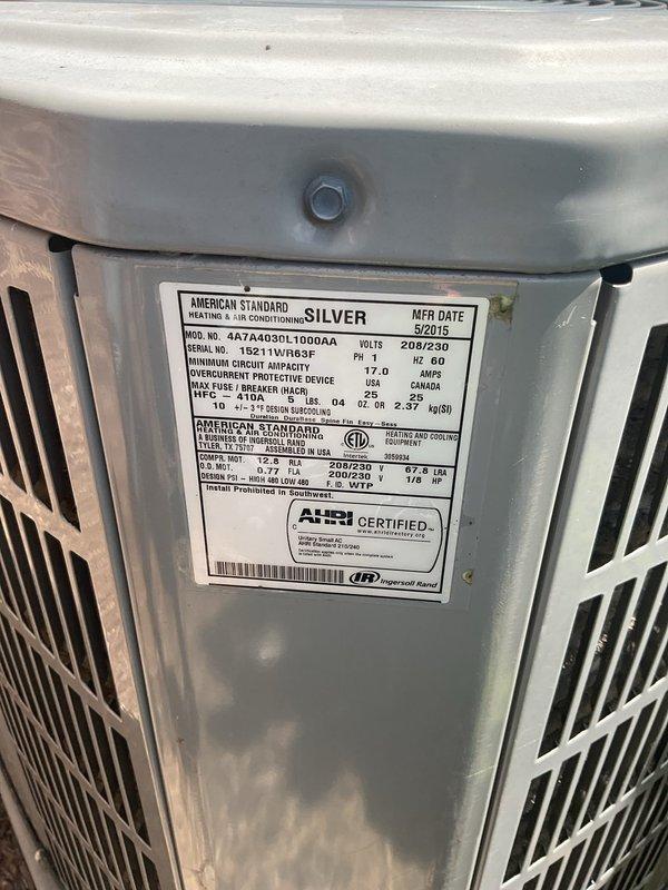 Performed cooling system evaluation for residential property with two AC units. Inspected outdoor American Standard Silver model (4A7A4030L1000AA, manufactured May 2015) and assessed second floor unit experiencing inadequate cooling performance during hot afternoon hours. Documented equipment specifications, verified unit condition, and photographed manufacturer data plate and interior return air grille to provide comprehensive replacement estimate for aging HVAC systems.