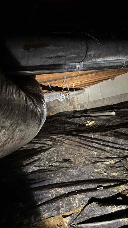 Conducted thorough inspection and evaluation of original 1974 crawl space ductwork system showing extensive age-related deterioration. Found significant structural damage including cracking, splitting, and material separation in main supply ducts, with visible staining and compromised integrity throughout the duct runs. Documented all findings with detailed photography for estimate preparation to replace the 52-year-old ductwork system.