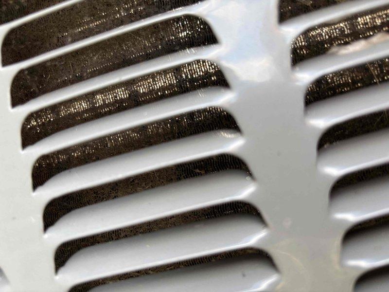 Responded to no cooling call on 23-year-old residential HVAC system with reported intermittent operation that had ceased functioning. Upon arrival, confirmed no airflow from supply vents and no breaker trips. Performed diagnostic inspection of system components including air handler and condensate drainage assembly. Visual inspection revealed heavily soiled return air filters with significant dust and debris accumulation restricting airflow, as well as evidence of moisture staining and mineral deposits around condensate drain fittings indicating potential drainage issues. Documented system condition through photographic evidence showing clogged filtration and corroded drain components. Advised property owner of findings related to compromised airflow and drainage concerns affecting system performance on aged equipment.
