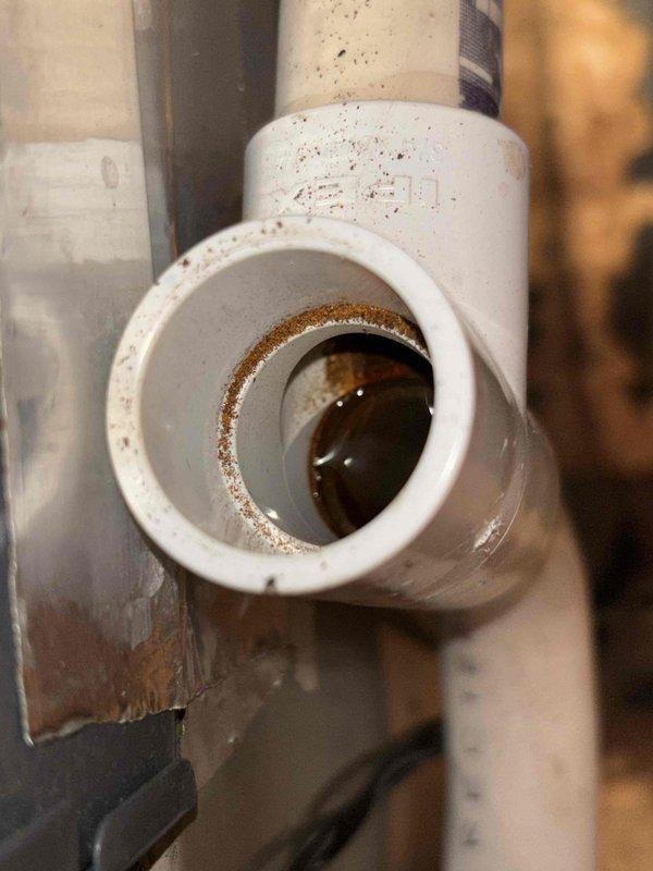 Responded to no cooling call on 23-year-old residential HVAC system with reported intermittent operation that had ceased functioning. Upon arrival, confirmed no airflow from supply vents and no breaker trips. Performed diagnostic inspection of system components including air handler and condensate drainage assembly. Visual inspection revealed heavily soiled return air filters with significant dust and debris accumulation restricting airflow, as well as evidence of moisture staining and mineral deposits around condensate drain fittings indicating potential drainage issues. Documented system condition through photographic evidence showing clogged filtration and corroded drain components. Advised property owner of findings related to compromised airflow and drainage concerns affecting system performance on aged equipment.