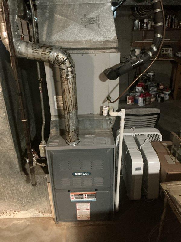 Responded to cooling system complaint on 9-year-old air conditioning unit. Upon inspection, identified refrigerant leak at condenser unit. Evaluated system components including AirEase furnace and associated ductwork in basement mechanical area. Documented equipment condition and leak location through photographic evidence. Provided customer with comprehensive estimate for complete HVAC system replacement due to age of equipment and extent of refrigerant leak, which made repair economically unfeasible compared to new installation.