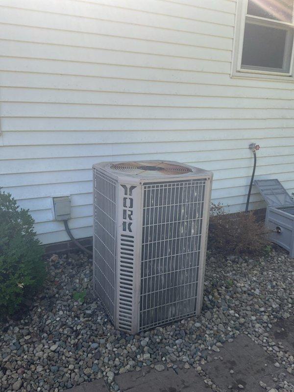 Conducted comprehensive HVAC replacement estimate for 30-year-old existing system in operational condition. Evaluated current downflow furnace configuration with coil and base assembly, documented equipment dimensions and clearance measurements, and assessed exterior condensing unit positioned on gravel pad with refrigerant line routing along exterior wall. Provided homeowner with equipment replacement options and system specifications for complete HVAC system upgrade.