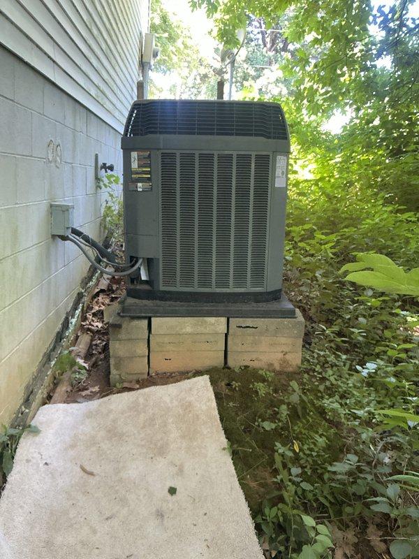 Responded to no cooling complaint on 20-year-old residential air conditioning system. Upon arrival, confirmed airflow present at registers but no cold air being delivered. Performed diagnostic evaluation of outdoor condensing unit and indoor air handler. Inspected refrigerant lines, electrical connections, and condensate drainage system in mechanical room. Evaluated condenser unit positioned in side yard on concrete pad with proper clearances. System showed signs of age-related wear and component degradation consistent with equipment at end of service life. Provided customer with findings and recommended options for repair versus replacement given the advanced age of the equipment.
