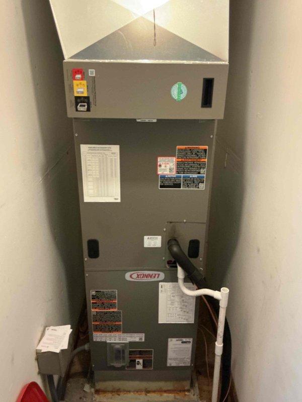 Completed installation of a 3.5-ton, 15.5 SEER Lennox heat pump system including indoor air handler and outdoor condensing unit. The air handler was installed in an interior closet space with proper condensate drainage via PVC piping, electrical connections, and all required safety labels and controls mounted and operational. The outdoor condenser unit was positioned on grade against the fence line with appropriate clearances, refrigerant lines connected and charged, and system commissioned and tested for proper operation.