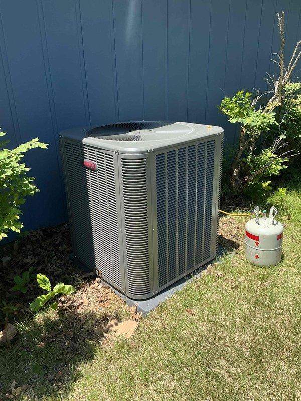 Completed installation of a 3.5-ton, 15.5 SEER Lennox heat pump system including indoor air handler and outdoor condensing unit. The air handler was installed in an interior closet space with proper condensate drainage via PVC piping, electrical connections, and all required safety labels and controls mounted and operational. The outdoor condenser unit was positioned on grade against the fence line with appropriate clearances, refrigerant lines connected and charged, and system commissioned and tested for proper operation.