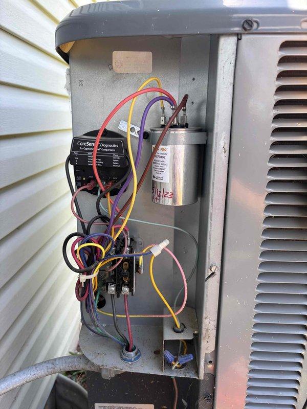 Completed routine preventative maintenance on a five-year-old residential HVAC system. Performed comprehensive AC tune-up inspection on outdoor condensing unit. Accessed electrical compartment and inspected all internal components including CoreSense control board, capacitor, contactor, and associated wiring connections. Verified all electrical connections were secure with proper wire routing throughout the compartment. Measured and recorded system temperatures using digital thermometer, confirming unit operating at 71.6°F. All components found in good working condition with no deficiencies noted. System currently functioning properly with no repairs required at this time.