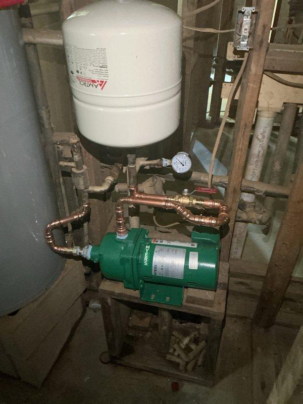 Installed new 1/2 HP well pump system with diaphragm expansion tank and pressure gauge in basement utility area, running new water lines and making all necessary connections to the existing plumbing system. Installed 50-gallon A.O. Smith electric short water heater with copper supply lines and red shut-off valve assembly. All equipment mounted securely on concrete floor with proper clearances, pressure monitoring capabilities in place, and system tested for proper operation upon completion.