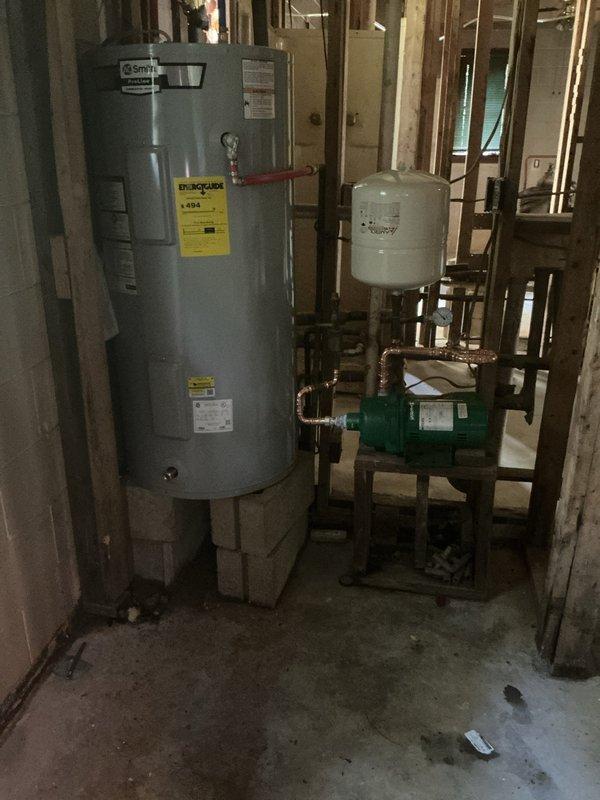 Installed new 1/2 HP well pump system with diaphragm expansion tank and pressure gauge in basement utility area, running new water lines and making all necessary connections to the existing plumbing system. Installed 50-gallon A.O. Smith electric short water heater with copper supply lines and red shut-off valve assembly. All equipment mounted securely on concrete floor with proper clearances, pressure monitoring capabilities in place, and system tested for proper operation upon completion.