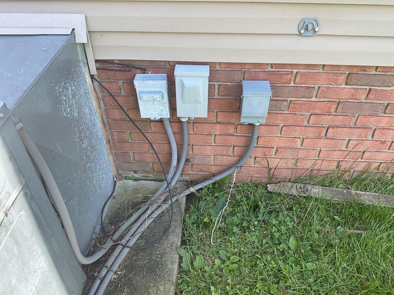 Conducted comprehensive replacement estimate for residential HVAC system over 20 years old that is no longer functioning adequately. Evaluated existing outdoor condensing unit showing significant age-related deterioration including rust staining on top panel and fan grille area, assessed electrical service configuration with multiple conduit runs along exterior brick foundation, and documented current system placement on concrete pad adjacent to landscaping. Provided homeowner with complete replacement options and specifications for new equipment installation to restore reliable climate control to the residence.