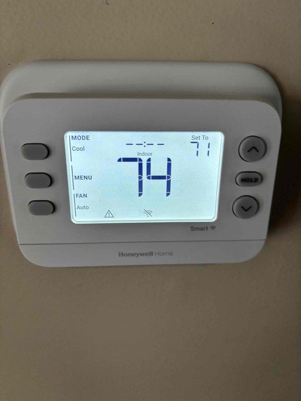 Completed routine planned maintenance and tune-up on two recently installed air conditioning units. Performed comprehensive system inspection, verified thermostat operation showing cooling mode set to 71 degrees with current temperature at 74 degrees, and inspected condensate drain piping configuration. Both units operating within normal parameters with no deficiencies noted.