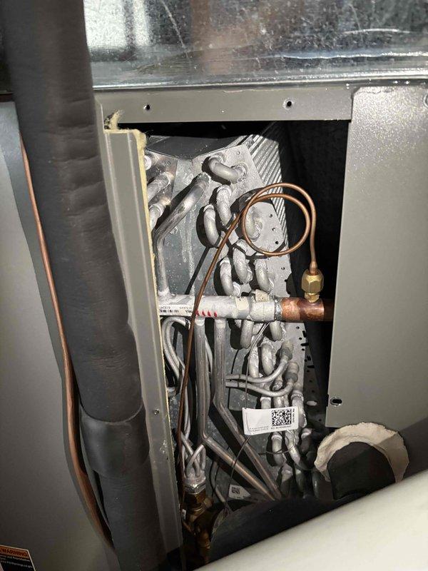 Completed annual first-visit planned maintenance on a 3-year-old single-system HVAC unit. Performed comprehensive inspection of indoor air handler compartment, examining copper refrigerant lines, coiled tubing, and connection points for proper operation and integrity. Replaced 16x25x5 air filter and inspected outdoor condenser unit positioned on exterior pad, verifying fan operation and coil condition. All components found operating within normal parameters with no immediate service needs identified.