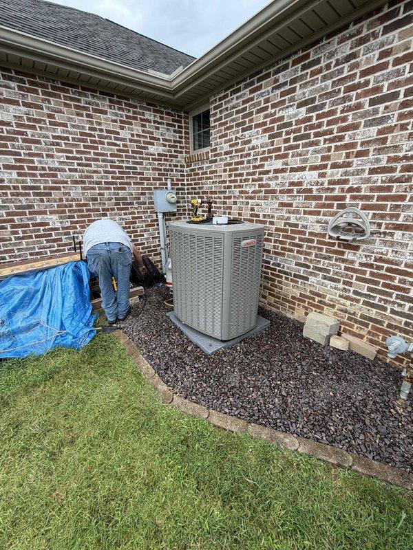 Completed installation of a 3-ton, 18 SEER complete HVAC system including outdoor condensing unit and indoor air handler with associated ductwork, refrigerant lines, condensate drainage, and electrical connections. The outdoor unit was positioned on a concrete pad at the building's exterior corner with proper clearances, while the indoor equipment was installed in the utility room with flexible insulated ductwork and PVC condensate piping routed to existing infrastructure. System was tested, charged to manufacturer specifications, and left in full operational condition.