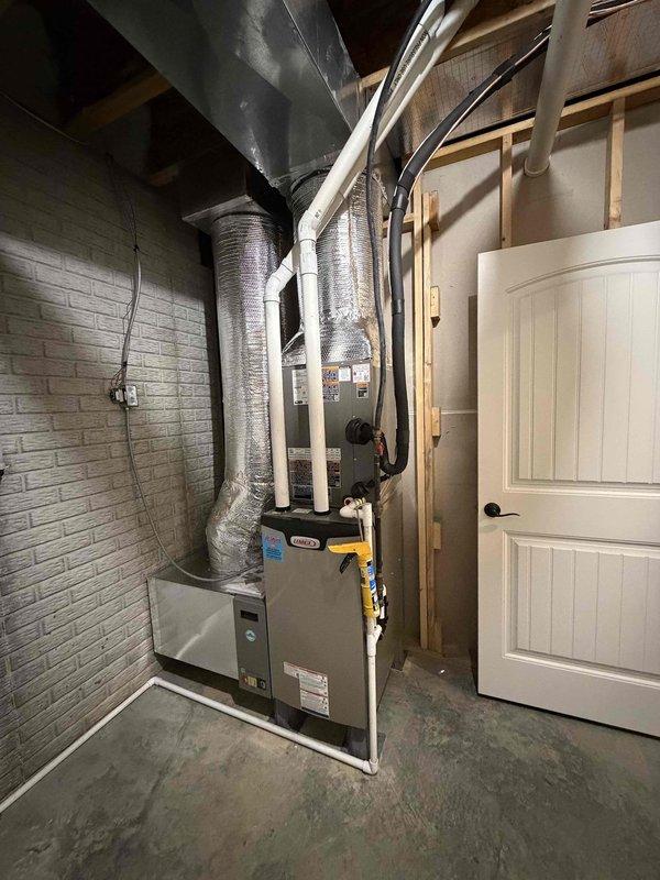 Completed installation of a 3-ton, 18 SEER complete HVAC system including outdoor condensing unit and indoor air handler with associated ductwork, refrigerant lines, condensate drainage, and electrical connections. The outdoor unit was positioned on a concrete pad at the building's exterior corner with proper clearances, while the indoor equipment was installed in the utility room with flexible insulated ductwork and PVC condensate piping routed to existing infrastructure. System was tested, charged to manufacturer specifications, and left in full operational condition.