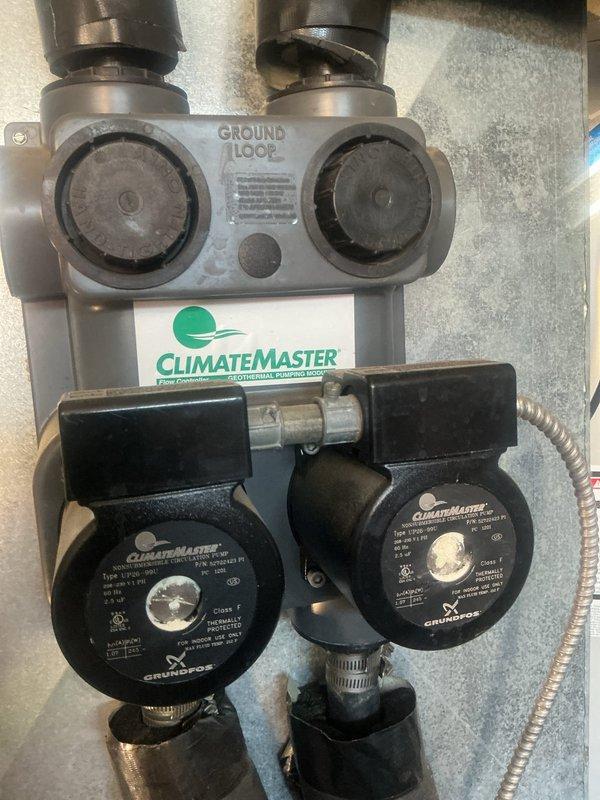 # Geothermal System Refrigerant Odor Investigation

Responded to customer concern regarding suspected refrigerant smell from supply vents on 15-year-old ClimateMaster geothermal heat pump system. Performed comprehensive system inspection including ground loop connections, circulation pumps, air handler, and all accessible refrigerant lines. Inspected Grundfos circulator pumps and ground loop manifold for proper operation and connections. Examined air handler internal components with cabinet open to check evaporator coil access points and filter condition. No refrigerant leaks detected during visual inspection or operational assessment. Determined odor was not refrigerant-related. System operating within normal parameters. Documented equipment condition with photographs for service records.