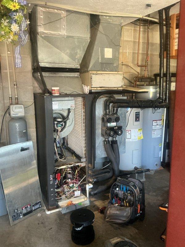 # Geothermal System Refrigerant Odor Investigation

Responded to customer concern regarding suspected refrigerant smell from supply vents on 15-year-old ClimateMaster geothermal heat pump system. Performed comprehensive system inspection including ground loop connections, circulation pumps, air handler, and all accessible refrigerant lines. Inspected Grundfos circulator pumps and ground loop manifold for proper operation and connections. Examined air handler internal components with cabinet open to check evaporator coil access points and filter condition. No refrigerant leaks detected during visual inspection or operational assessment. Determined odor was not refrigerant-related. System operating within normal parameters. Documented equipment condition with photographs for service records.
