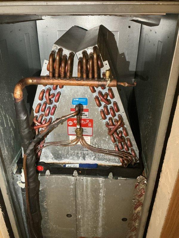 Completed comprehensive spring maintenance tune-up on central heat pump system. Performed standard preventive maintenance procedures including inspection of evaporator coil assembly, verified proper refrigerant line connections, checked system controls and safety devices, and assessed overall unit operation. System found to be functioning within normal parameters with no immediate service needs identified; evaporator coil shows age-appropriate patina but remains serviceable.