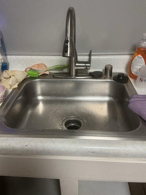 Successfully completed kitchen sink plumbing installation including repiping the drain line from the sink to the garbage disposal unit with new white PVC trap assembly and connections. Additionally performed drain line snaking service to clear the kitchen sink drain and restore proper water flow.