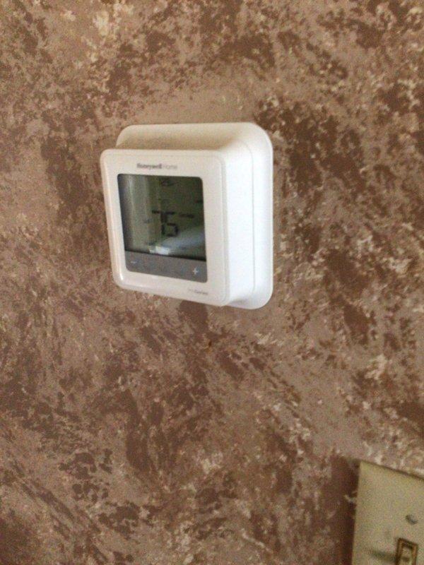 Completed planned maintenance visit on a 6-year-old single-system HVAC unit as part of annual service agreement. Inspected and verified operation of Honeywell thermostat displaying proper temperature reading, examined outdoor condensing unit with cylindrical configuration and confirmed adequate clearance from building structure, and documented system condition through photographic records. Unit operational and ready for continued service with renewal recommendation for ongoing maintenance coverage.