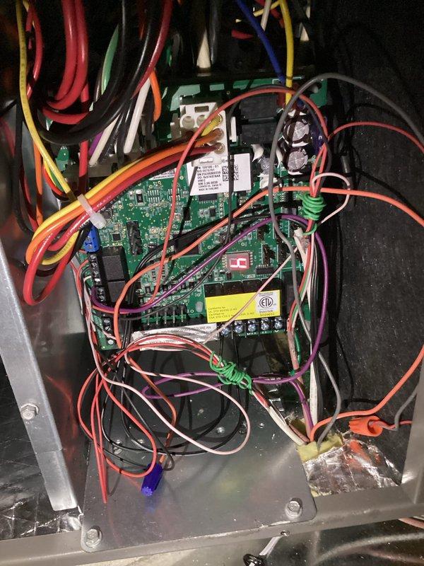 Completed first scheduled maintenance visit on HVAC system as part of three-month planned maintenance program. Inspected and photographed control board assembly showing proper operation of all circuits, relays, and terminal connections with appropriate wire routing and no signs of electrical damage. Documented standing water condition in crawl space area requiring attention, with level tool used to assess floor drainage issues that could potentially affect equipment longevity if not addressed.